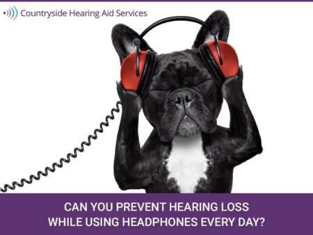 A black and white French Bulldog with closed eyes holds large red headphones over its ears. The image includes text from Coun