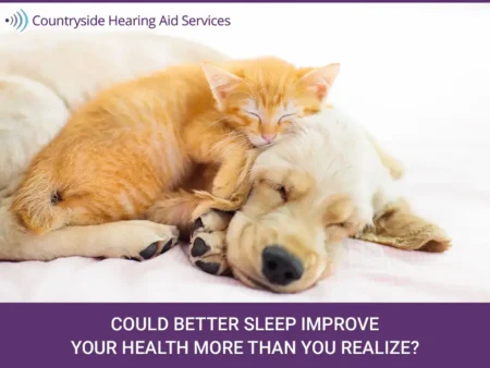Orange kitten sleeping on a light-colored dog with headline about better sleep and health by Countryside Hearing Aid Services