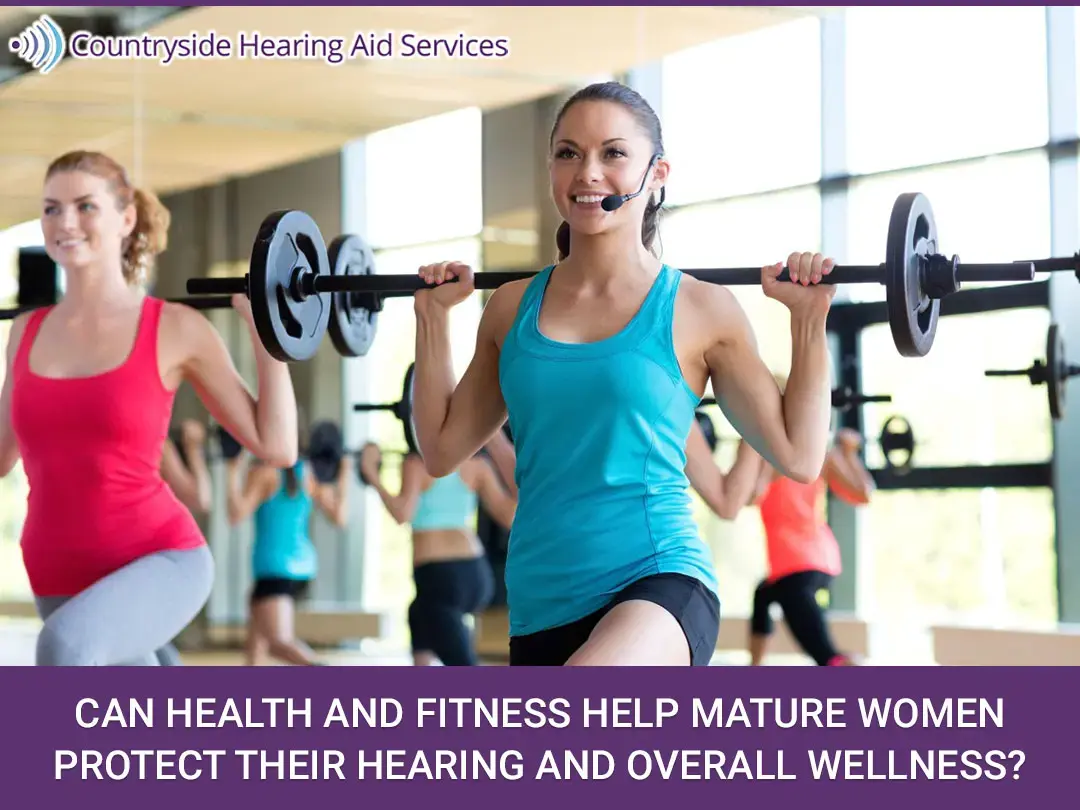 Can Health and Fitness Help Mature Women Protect Their Hearing and Overall Wellness? Women exercising in a gym holding weighted bars above their shoulders