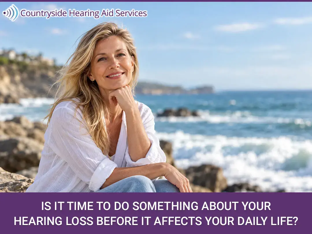 Smiling woman sitting by the ocean with text about addressing hearing loss from Countryside Hearing Aid Services